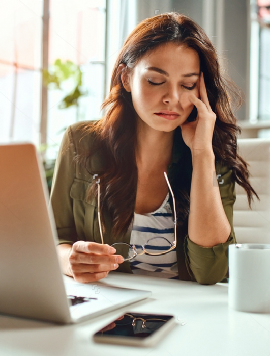 woman-sitting-at-desk-clasping-face
